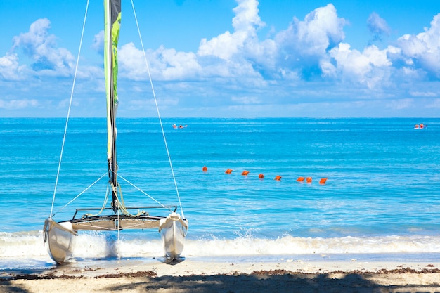 Plage tropicale avec un voilier coloré sur une journée d'été avec de l'eau turquoise et un ciel bleu. Varadero resort, Cuba.