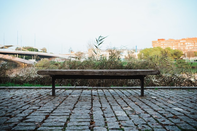 Plan frontal d'un banc public à côté de la rivière dans la ville