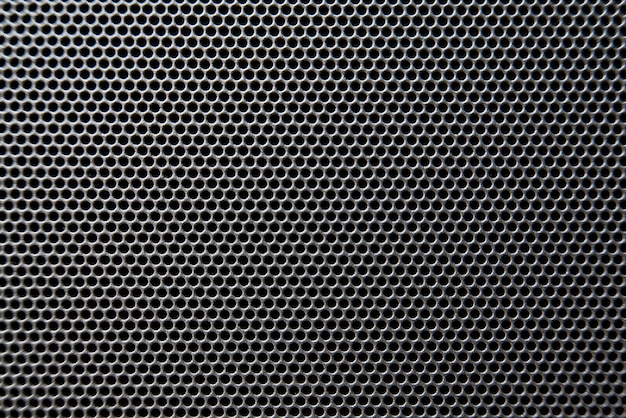 Plan macro sur le détail de la grille du haut-parleur, la texture de la grille du haut-parleur
