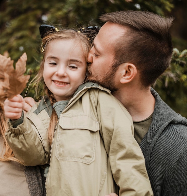 Photo plan moyen père embrassant sa fille