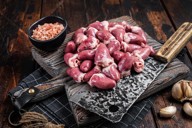 Planche de boucher avec coeurs de poulet cru Fond en bois Vue de dessus