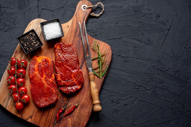 Une planche à découper avec de la viande et des épices dessus