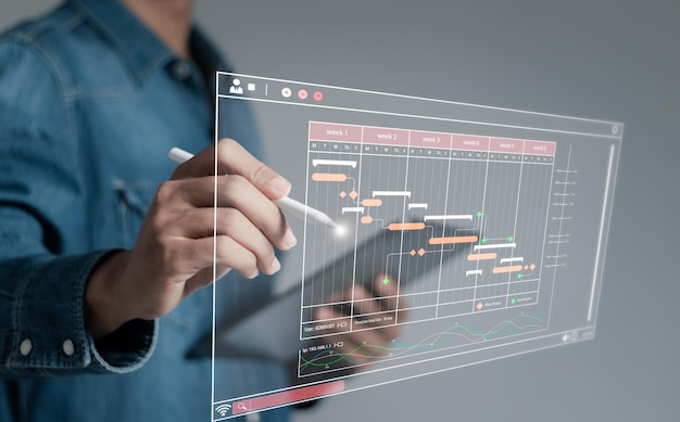 Photo planificateur de projet en logiciels mise à jour et gestion des étapes sur une chronologie graphique de gantt en technologie plan d'horaire en ligne gestion de la mise à jour du travail et du flux de travail concept de nomination personnel de l'entreprise