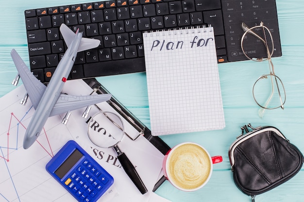 Plans 2018 sur ordinateur portable avec portefeuille de lunettes accessoires voyageur et avion sur fond de table en bois. Voyage concept de vacances de vacances de nouvel an.