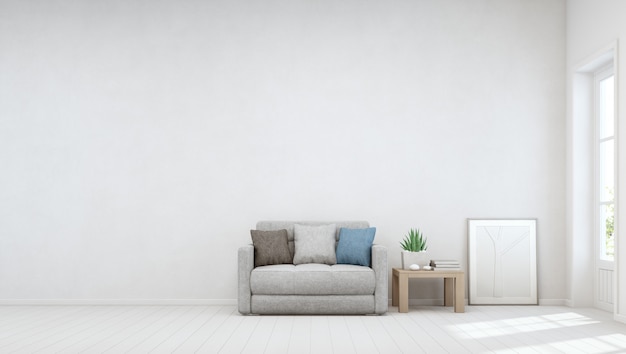 Plante d'intérieur sur table basse en bois et petit canapé avec mur de béton blanc vide