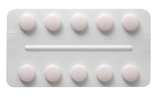 Plaque avec des pilules blanches isolé sur fond blanc