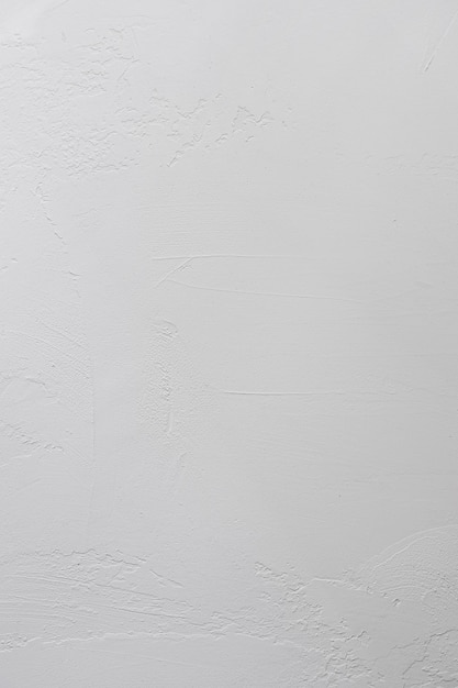 Plâtre blanc sur le mur en gros plan, fond vertical