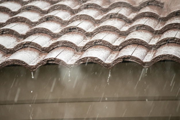 Pluie tombant du toit de la maison