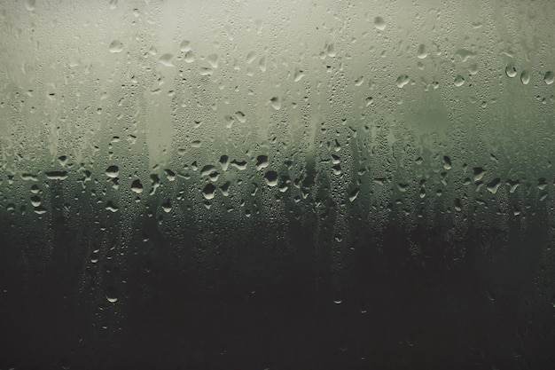 Photo la pluie tombe sur la surface de la fenêtre