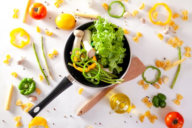 Poêle à frire et légumes frais avec cuisson