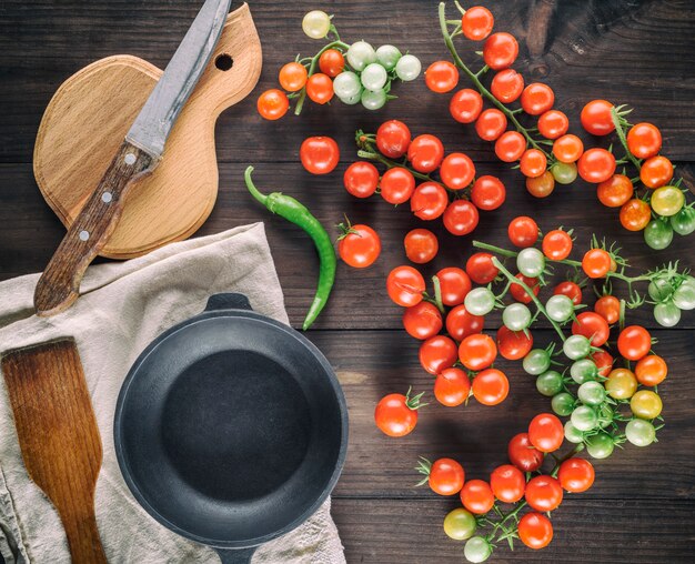 Poêle ronde en fonte et tomates cerises rouges bien mûres