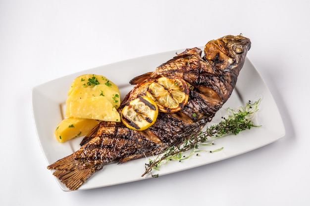 Poisson carpe grillé avec pommes de terre au romarin et citron