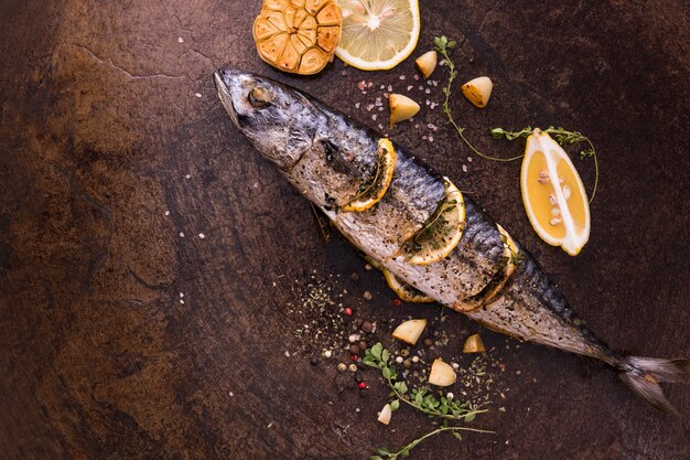 Poisson grillé et divers légumes dans une assiette en fer