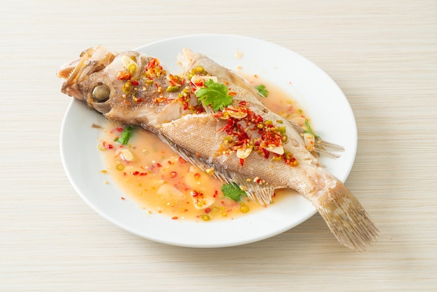 Poisson de mérou cuit à la vapeur avec citron vert et piments - style cuisine asiatique