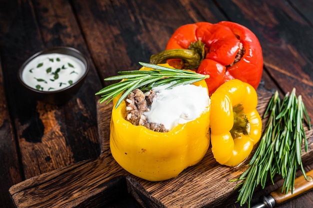 Poivron rôti farci de viande de bœuf, riz et légumes sur une planche de bois