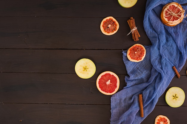 Pomme, pamplemousse et cannelle sur tissu bleu