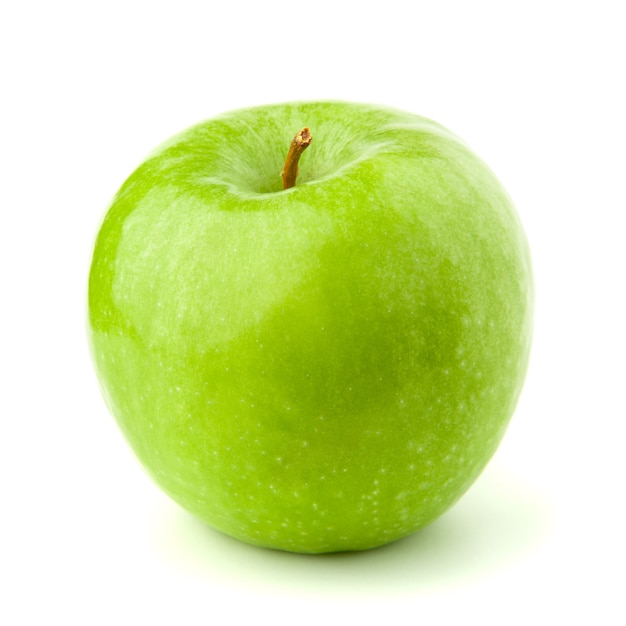 Pomme verte sur une surface blanche avec une ombre.