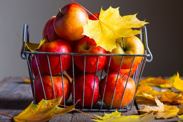 Pommes dans un panier sur une table en bois