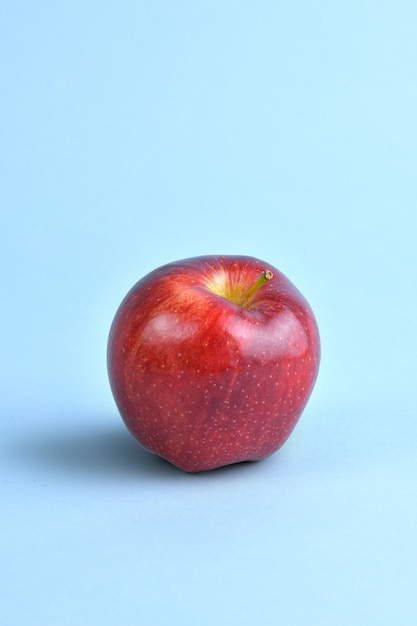 Pommes rouges pleines sur fond bleu clair