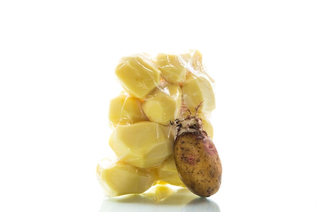 Pommes de terre épluchées fermées dans un sac sous vide et vieilles pommes de terre germées sur fond blanc
