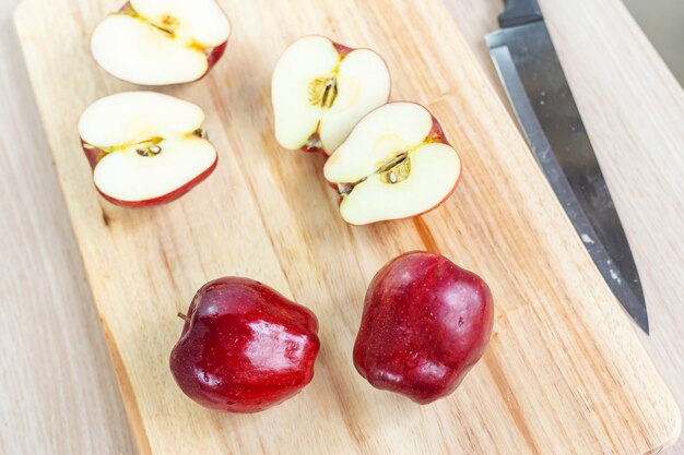 Pommes et tranches sur une planche à découper en bois.