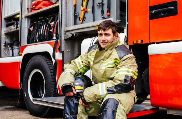 Pompier en casque de protection Héros homme adulte en uniforme d'équipement au travail