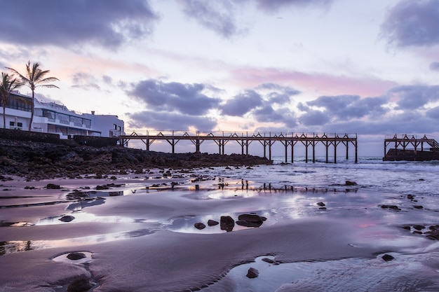 Pont sur la plage au coucher du soleil