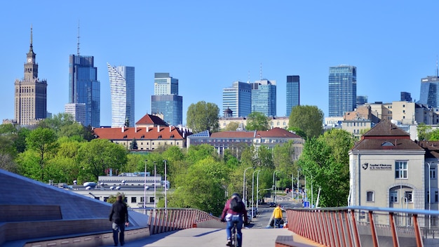 Photo un pont avec quelques personnes sur des vélos et une ville en arrière-plan