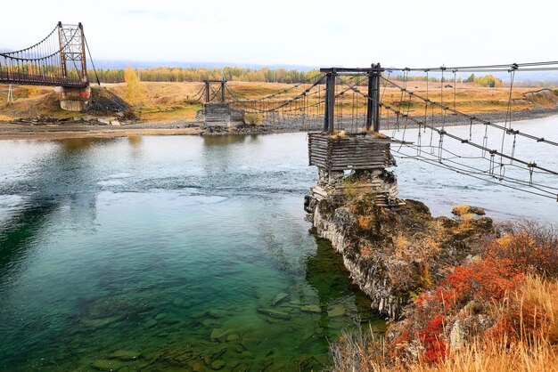 pont suspendu de l'autre côté de la rivière, vue sur l'altaï vieux pont traversant délabré