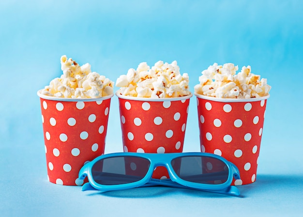 Popcorn avec des lunettes 3d sur fond bleu