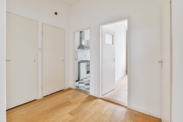 Porte d'appartement moderne avec murs blancs et parquet