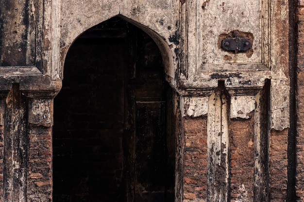 Porte d'entrée d'un ancien bâtiment hanté endommagé