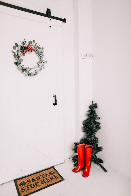 Porte avec entrée de maison de guirlande de Noël décorée pour Noël et nouvel an