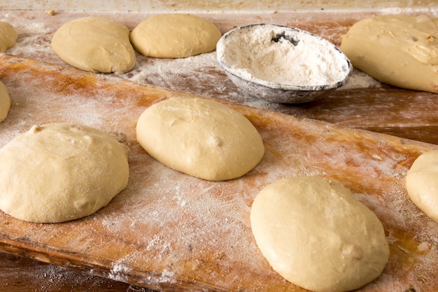 Des portions de pâte à pain sur une table dans une boulangerie