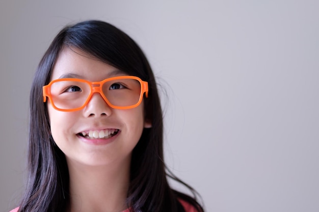 Portrait d'adolescent asiatique avec de grands verres oranges