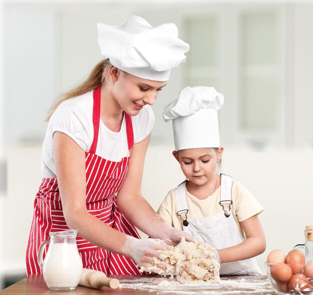 Portrait d'une adorable petite fille et de sa mère cuisinant ensemble