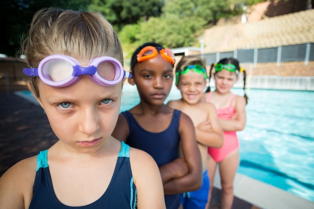 Photo portrait d'amis debout au bord de la piscine