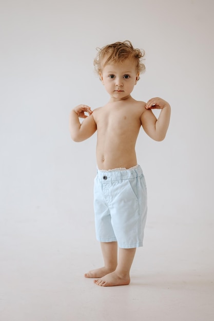 Portrait de beau bébé aux cheveux blonds sur fond blanc