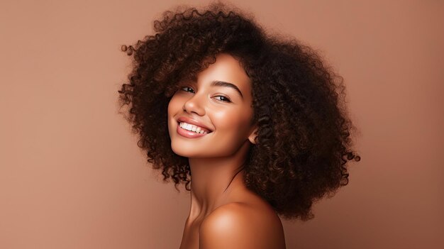 Portrait de beauté d'une fille afro-américaine avec une peau propre et saine sur fond beige Souriante belle femme noire de rêveCheveux bouclés dans un style afro