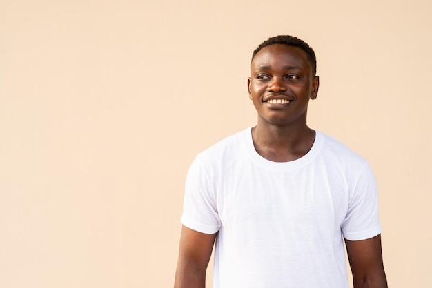 Portrait d'un bel homme africain portant un t-shirt blanc