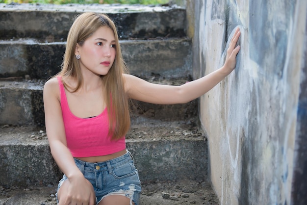 Portrait d'une belle femme sexy asiatique dans un ancien bâtimentPose pour prendre une photoThaïlandeStyle de vie d'une fille moderne