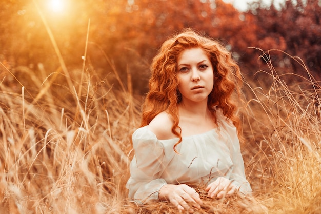 Portrait d&#39;une belle fille aux cheveux rouges dans le champ