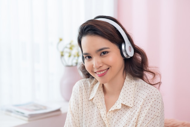 Portrait de la belle jeune femme asiatique, écouter de la musique
