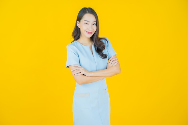 Portrait belle jeune femme asiatique sourire avec action sur fond de couleur