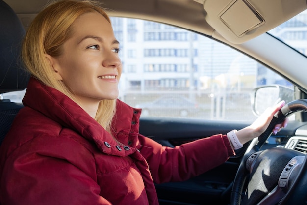 Portrait d'une belle jeune femme au volant d'une voiture