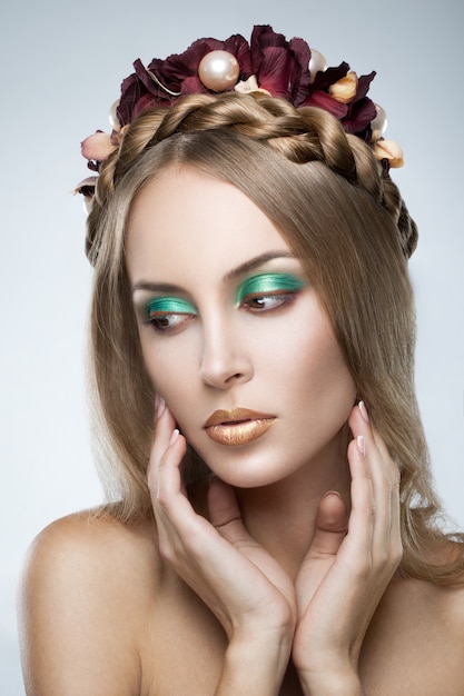 Photo portrait de la belle jeune femme blonde avec des fleurs dans les cheveux