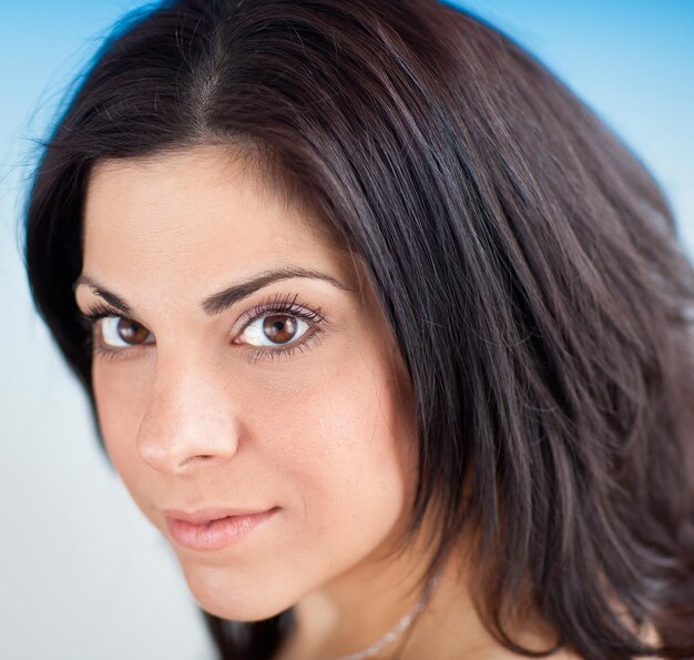 Photo portrait d'une belle jeune femme sur un fond bleu