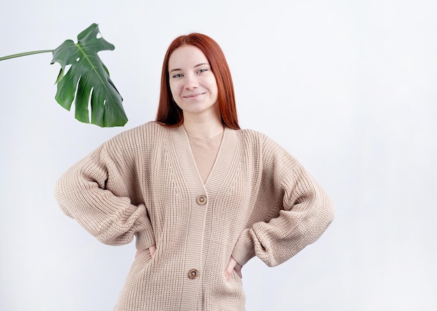 Portrait d'une belle jeune femme en vêtements beiges posant sur l'espace de copie de fond blanc