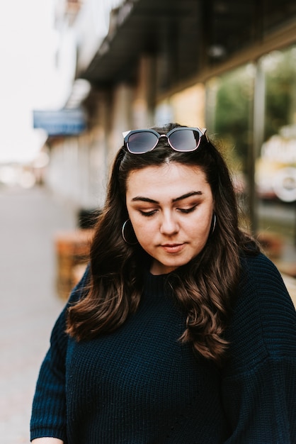 Portrait d'une belle jeune fille adulte dans un pull chaud dans une rue de la ville