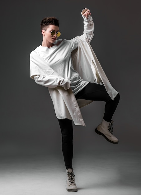 Portrait d&#39;une belle jeune fille portant un manteau blanc et des lunettes de soleil